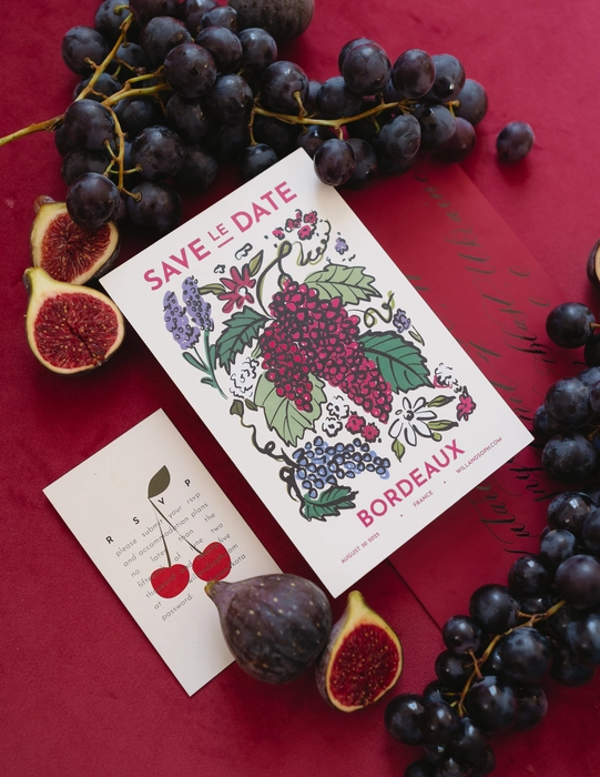 Wedding invitation suite with vineyard illustration in red flat lay, elegant Provence destination wedding stationery