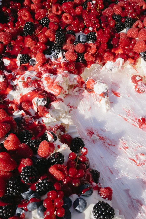 Close-up of raspberry and cream wedding cake after cutting, elegant reception detail at Provence destination wedding at Chateau les trois Fontaines