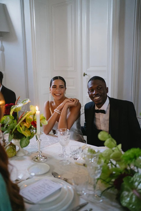 Bride and groom smiling during candlelit wedding dinner at Château des Trois Fontaines in Provence, luxury destination wedding France